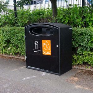 Mini Cyclo Double Litter Bin in all black in front of a bush.