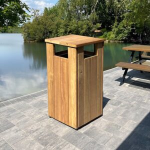 WTS/8 Iroko Wood Litter Bin by a lake.