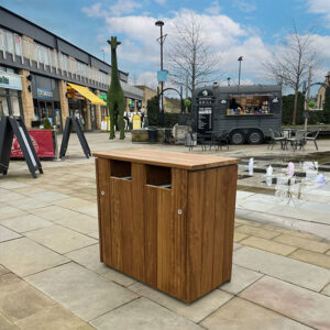 WTS/8 Double Iroko Wood Litter & Recycling Bin at an outdoor shopping centre.