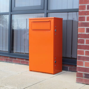 The Knife Amnesty Bin in orange outside an office building.