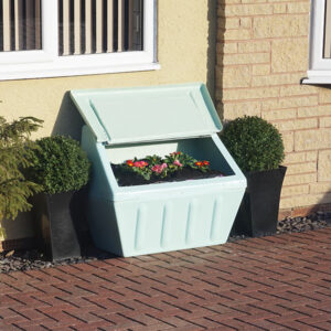 Pastel Green Glass Reinforced Plastic Garden Storage Unit with flowers inside.