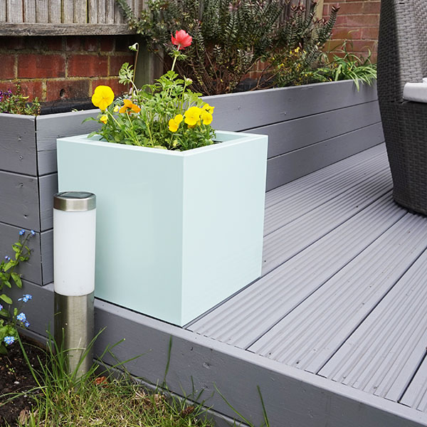 Pastel Green Medium Square Flower Planter on grey garden decking.