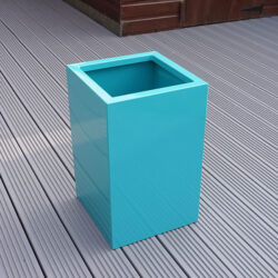 Turquoise Tall Flower Planter with no flowers inside.