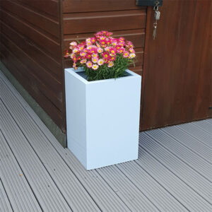Pastel Blue Tall Flower Planter next to a brown garden shed.