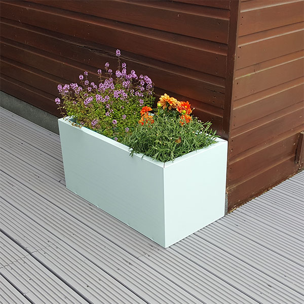 Pastel Green Rectangular Flower Planter next to a brown shed.