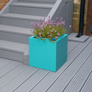 Turquoise Square Flower Planter on grey garden decking