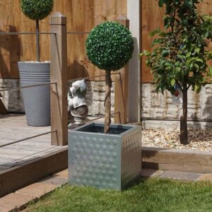 Wybone Galvanised Steel Honeycomb-styled planter in a garden.