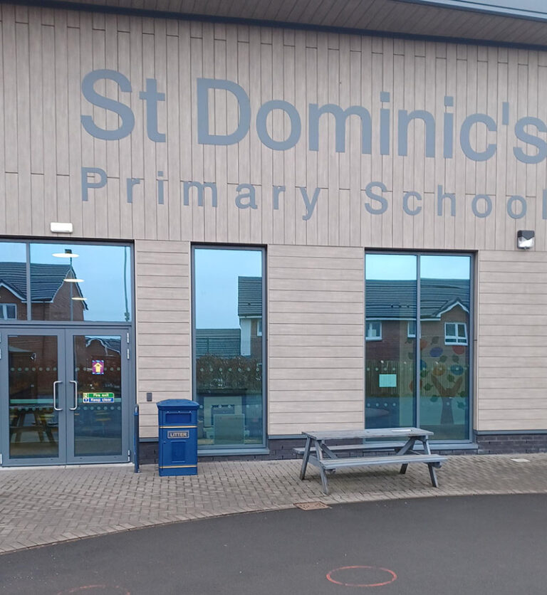 The blue Compass Litter Bin outside St Dominic's Primary School.