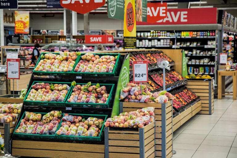 Fruit and vegetables on shelves at a food shop.