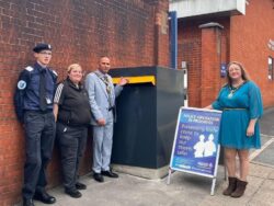 Greater Manchester Police officers unveiling new Wybone Knife Surrender Amnesty Bins to promote public safety and reduce knife crime.